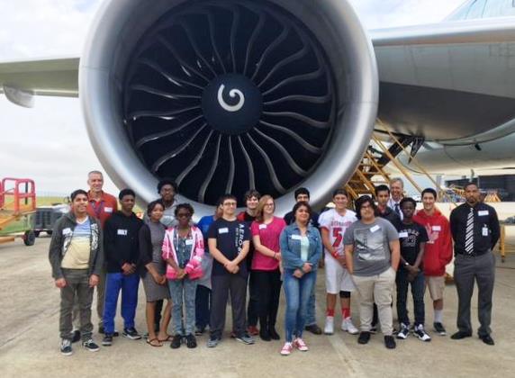 Aviation academy students in front of jet engine Aviation academy students in front of jet engine
